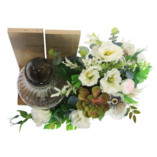 Arrangement of artificial flowers in a wooden frame with a candle holder