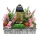 Artificial flowers, wooden basket with grave candle