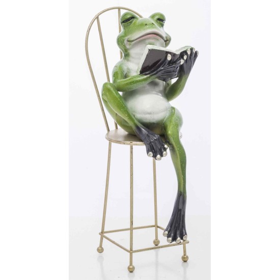 A frog in a chair with a book