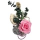 A composition of a sleeping rose in a ceramic vase